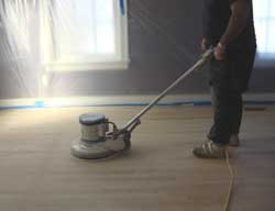 Once the plastic is all in place, it's time to start sanding the floors