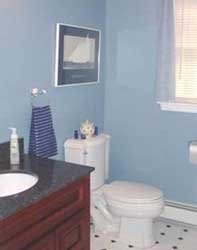 A basic bathroom makeover included new vanity, counter top, sink, mirror and tile floor