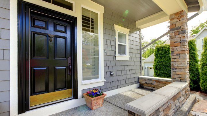When picking a front door, pick a home exterior material that's easy to maintain & fits your personality ... like this large, black door with side window