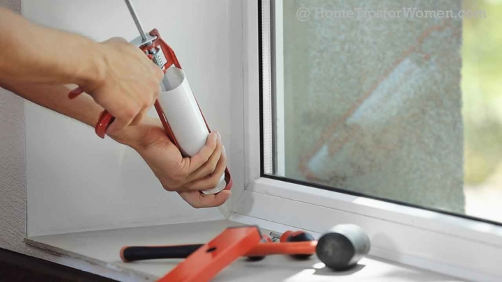 Caulking an interior window using a caulking gun ...