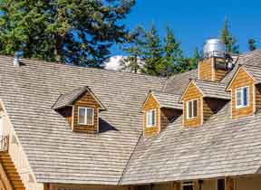 exterior home maintenance starts with the roof, where there are seams around chimneys & dormers