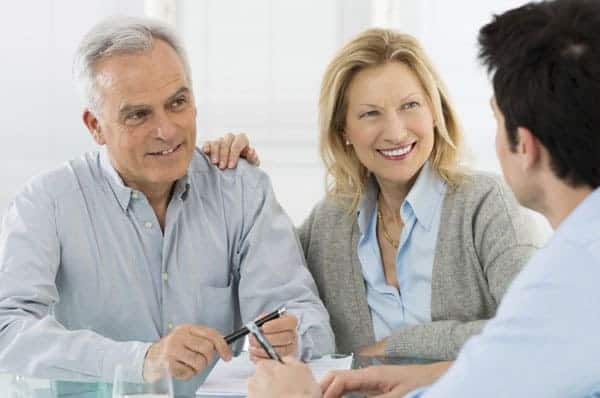 older couple talking to loan office about home affordability factors