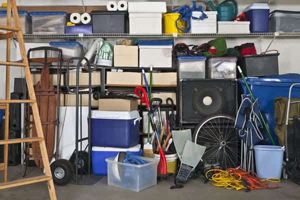 A very messy garage in need of DIY garage organization so you can find things easily