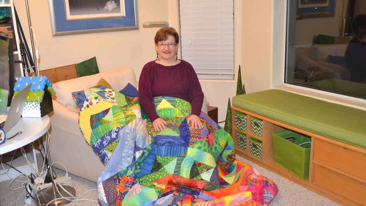 Tina Gleisner, founder of Home Tips for Women, sharing one of her colorful quilts