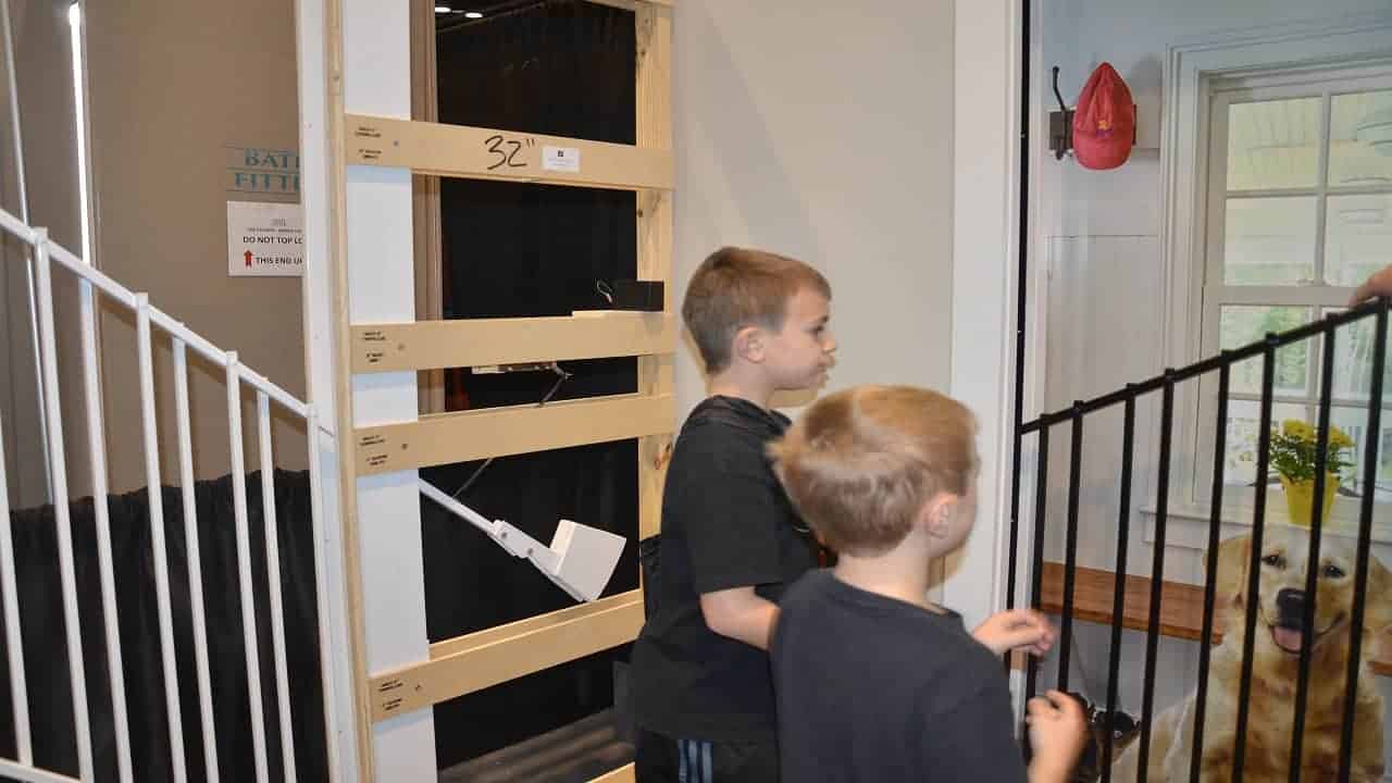 inventor showing the boys how his baby gates work