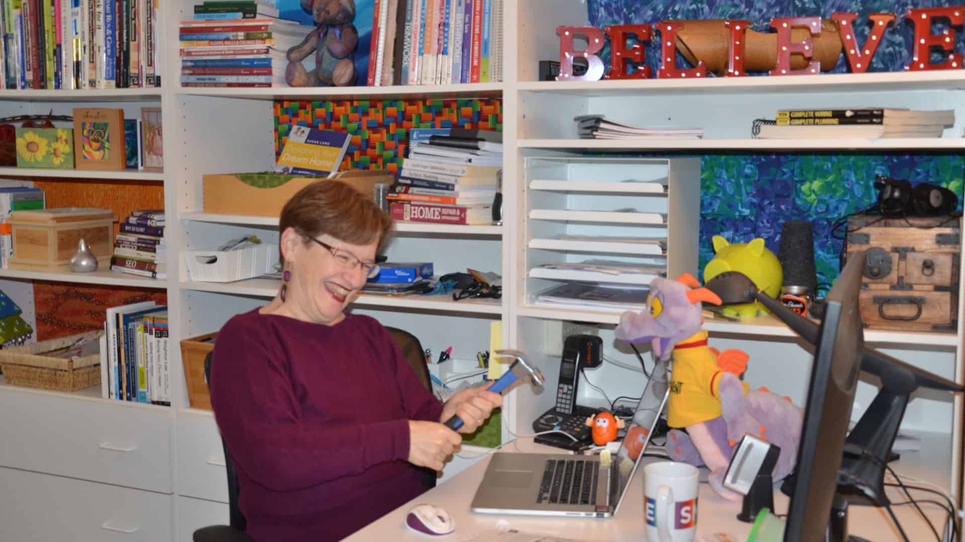 Tina Gleisner, founder of HomeTipsforWomen.com, surrounded by books on anything home, her laptop & lots of color