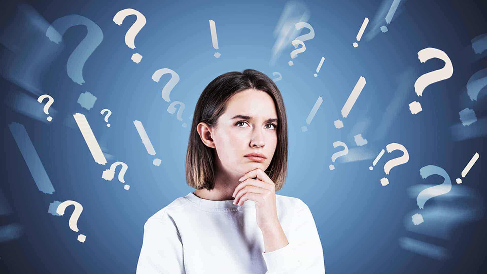 Woman surrounded by question marks as shes trying to decide how to approach finding anything home