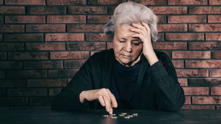 Woman counting coins to see if she can buy some food ... an example of food insecurity