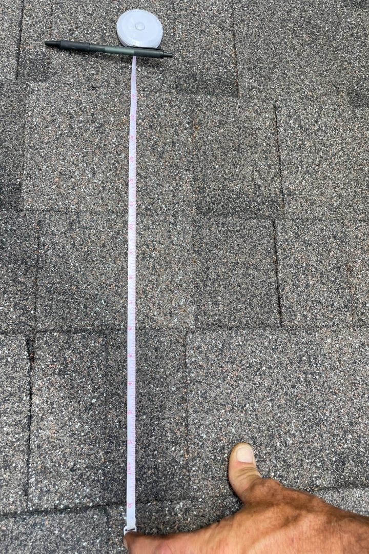 Tape measure showing rows of shingles vary in height from 4.5 to 6 inches ...